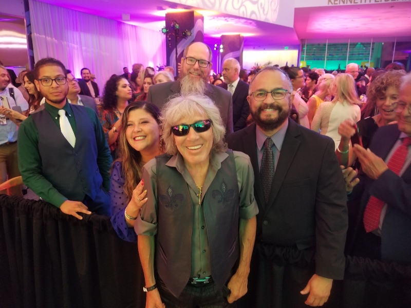  Ricardo and few more people stand behind José Feliciano at the Smithsonian exhibit