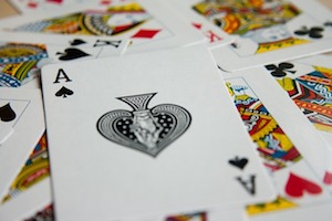 playing cards spread on a surface, an ace on top