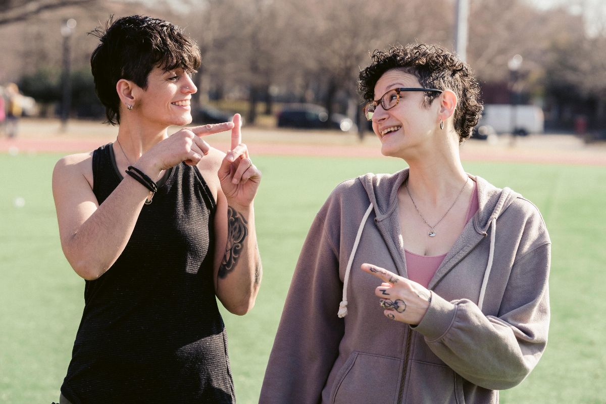 two women talking outside in ASL