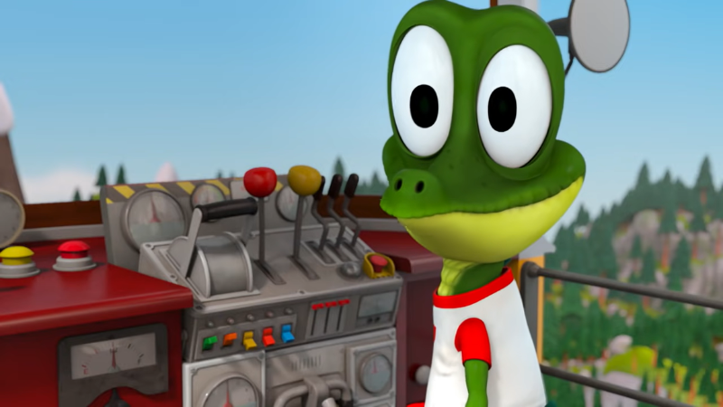 Ziggy, an animated cartoon crocodile, is smiling in front of the plugs and levers of a train background.