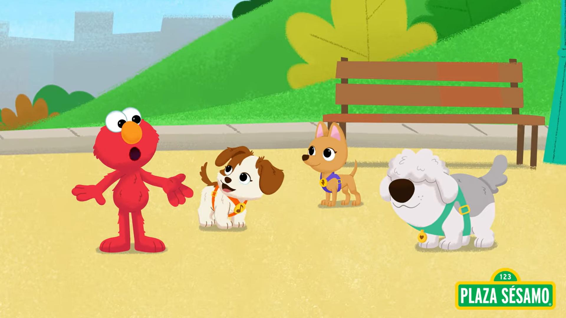 Elmo stands with three dogs at a park, including Tango, with a Plaza Sésamo sign in the bottom right corner.