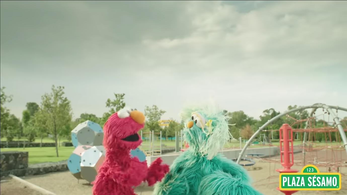 Sesame Street characters, Elmo and Rosita, at a playground