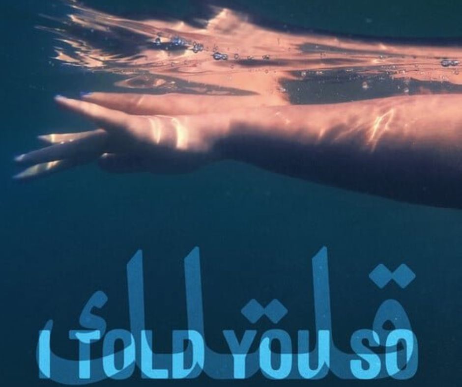 A woman's arm is extended beneath the water's surface, with the phrase I Told You So written in blurred letters in both Arabic and English.