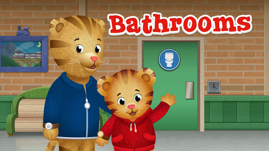 Cartoon tigers from Daniel Tiger, one adult and one child, stand in front of a restroom with a toilet icon and "Bathrooms" in bold red letters. The restroom is accessible, with a wheelchair symbol. The tigers wear blue and red jackets, respectively.